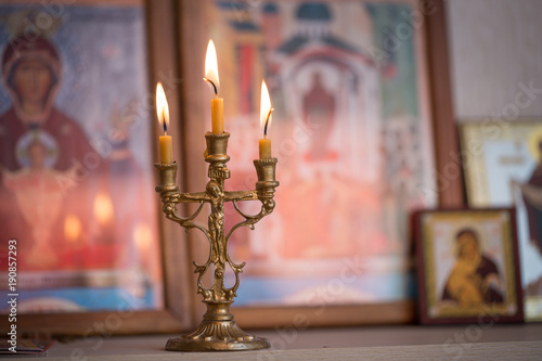 candle against the background of orthodox icons