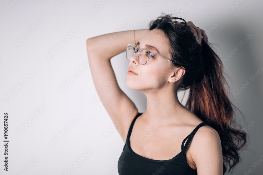 Woman in glasses and dreamy looks away Woman in glasses and dreamy looks away