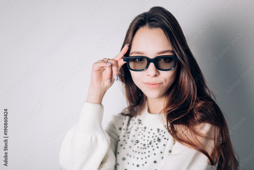 Young beautiful woman with 3d glasses with a smile looking at the camera