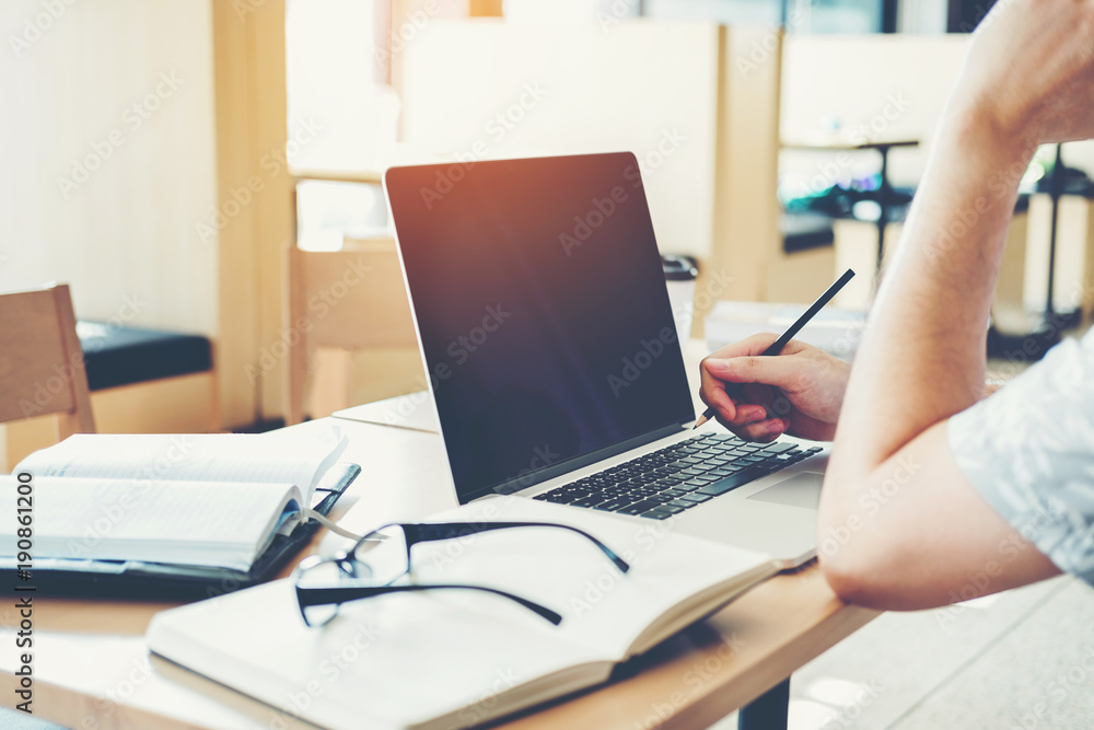 Fototapeta premium University students using laptop meeting for research homework in college