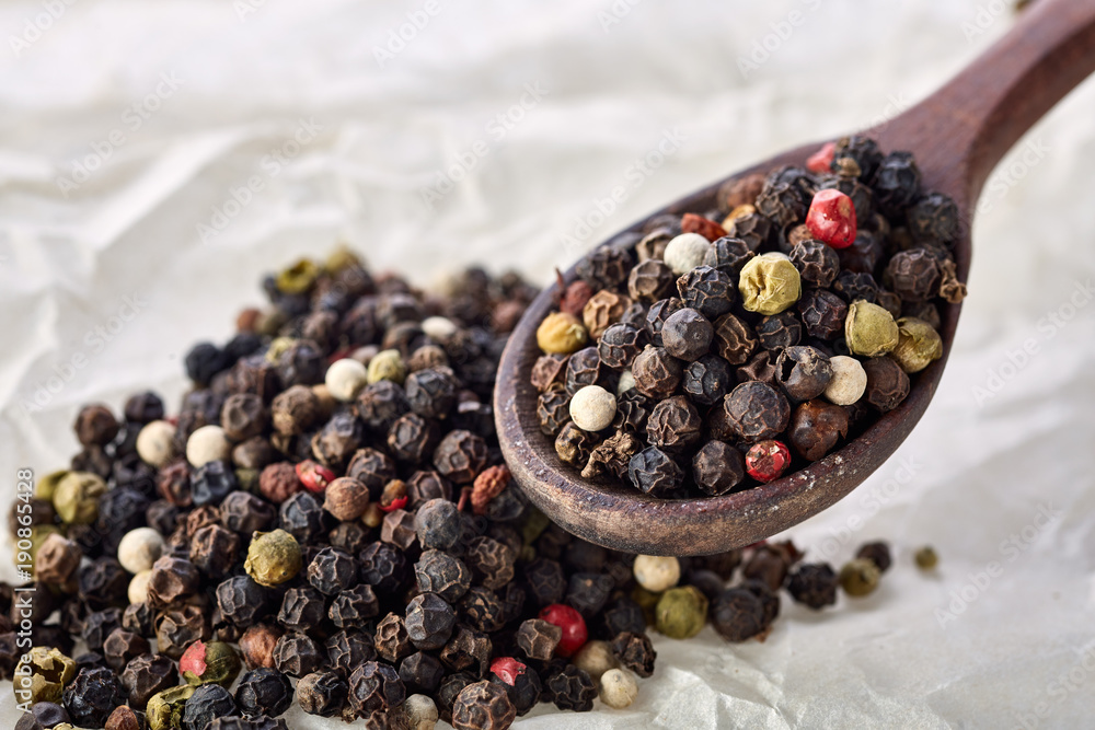 black pepper peas on a wooden spoon black pepper peas on a wooden spoon