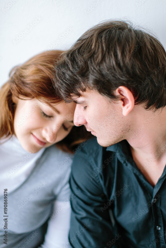 love, happiness, harmony concept. there is young gorgeous couple of lovers, wife and her husband, they are dreaming leaning on the each other and smiling love, happiness, harmony concept. there is young gorgeous couple of lovers, wife and her husband, they are dreaming leaning on the each other and smiling