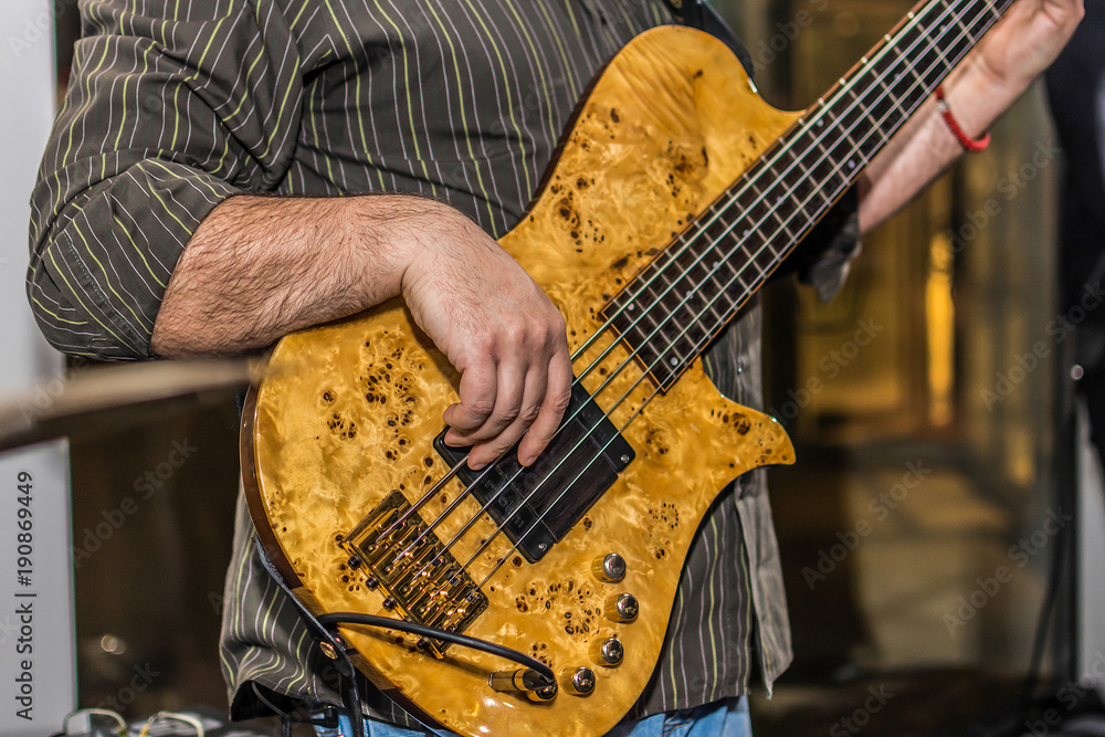 Fototapeta premium Close-up photo of bass guitar player 