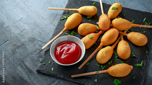 Photography Mini Corn Dogs on stone platter with ketchup