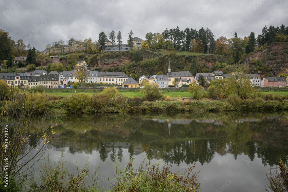 Detail of Moselle river valley with typical village houses near Trier in rainy day in November, Germany. Dark autumn landscape.