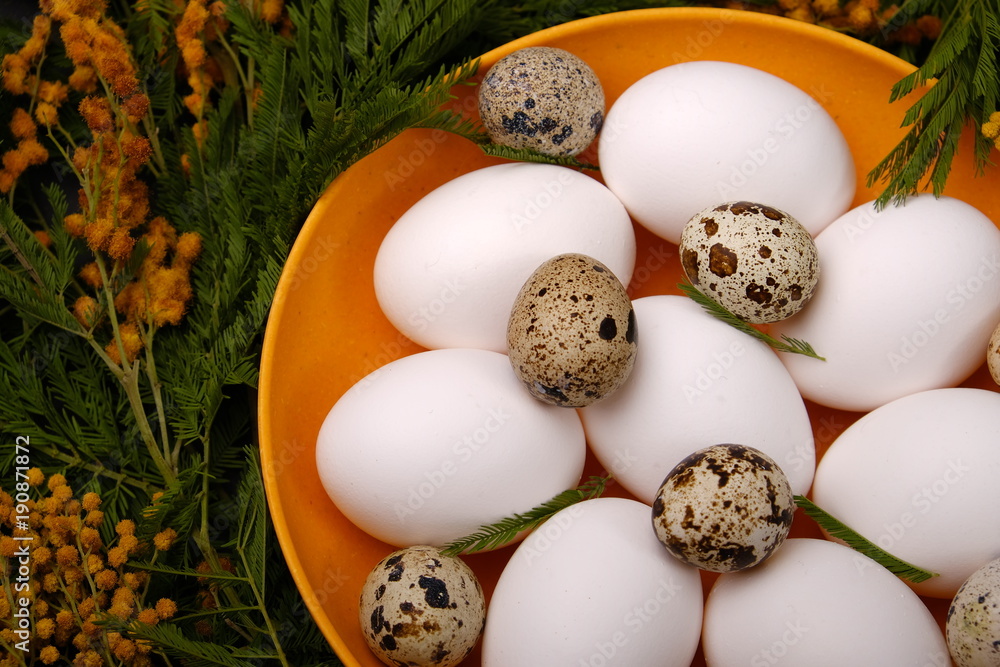 Easter table setting with white eggs with mimosa flower selective focus image. Happy Easter. Easter table setting with white eggs with mimosa flower selective focus image. Happy Easter.