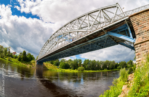 First in Russia steel arch bridge on river Msta in sunny summer day. Was built in 1905. Borovichi, Russia