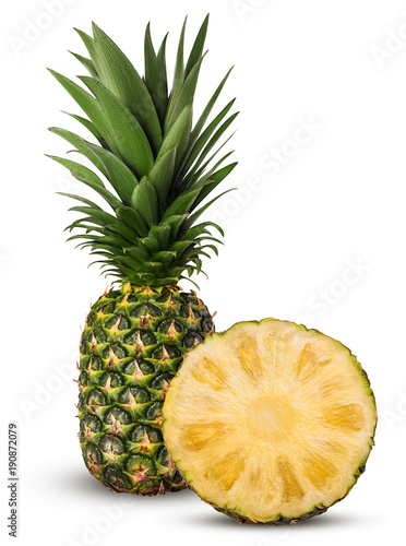 Pineapple fruit whole and cut in half with green leaves
