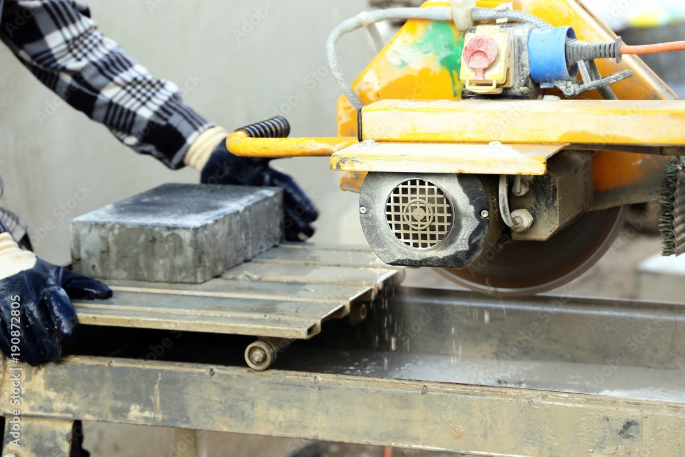 Worker on the circular tile saw
