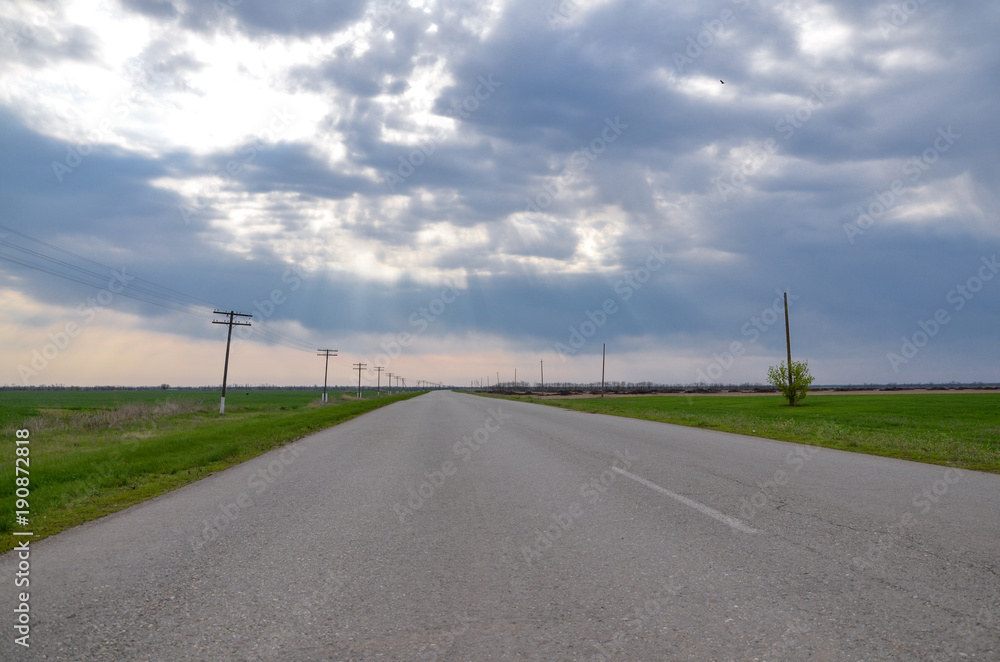 empty rural road between green fields in steppe near Novyy Yegorlyk, Rostov region, Russia empty rural road between green fields in steppe near Novyy Yegorlyk, Rostov region, Russia