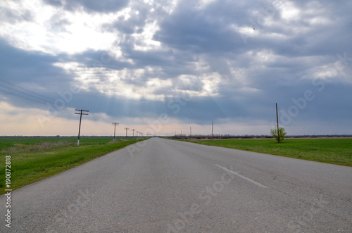 empty rural road between green fields in steppe near Novyy Yegorlyk, Rostov region, Russia © ssmalomuzh