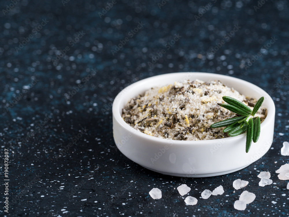 Sea salt scented herb rosemary on dark blue background Sea salt scented herb rosemary on dark blue background