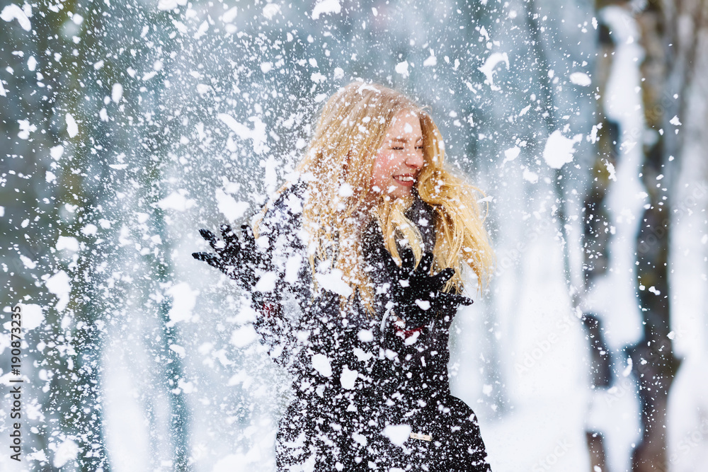 Winter young teen girl portrait. Beauty Joyful Model Girl laughing and having fun in winter park. Beautiful young woman outdoors. Enjoying nature, wintertime Winter young teen girl portrait. Beauty Joyful Model Girl laughing and having fun in winter park. Beautiful young woman outdoors. Enjoying nature, wintertime
