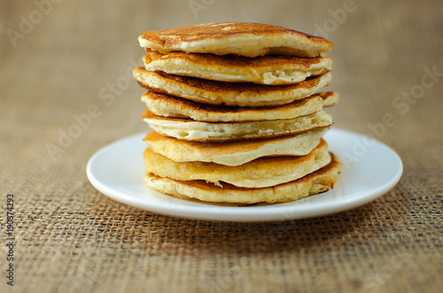 Fried pancakes are a mountain on a plate of sweets