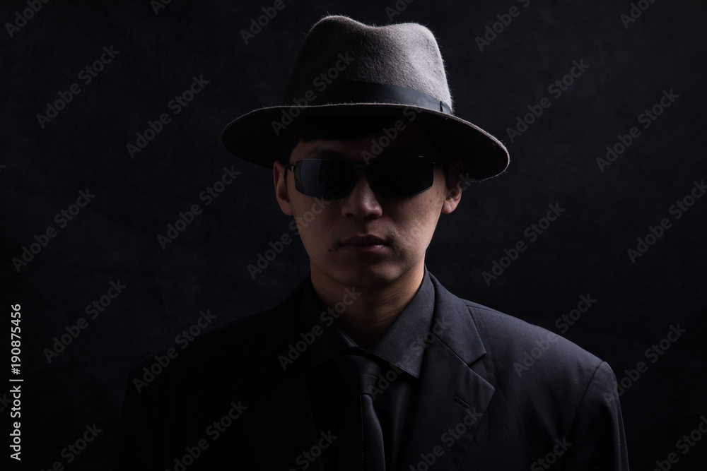 Portrait of a young Asian man. Close-up face on a black background Portrait of a young Asian man. Close-up face on a black background