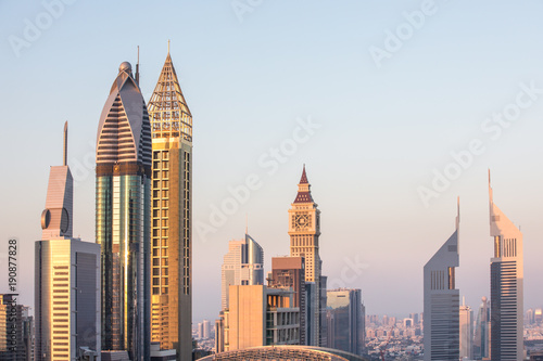 The skyline of Dubai DIFC district during a colorful sunset as viewed from a rooftop. Dubai  UAE.