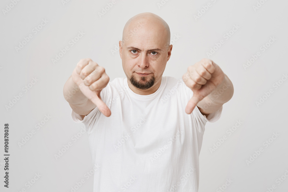 Free Photo  Very bad portrait of bearded guy shows thumbs down