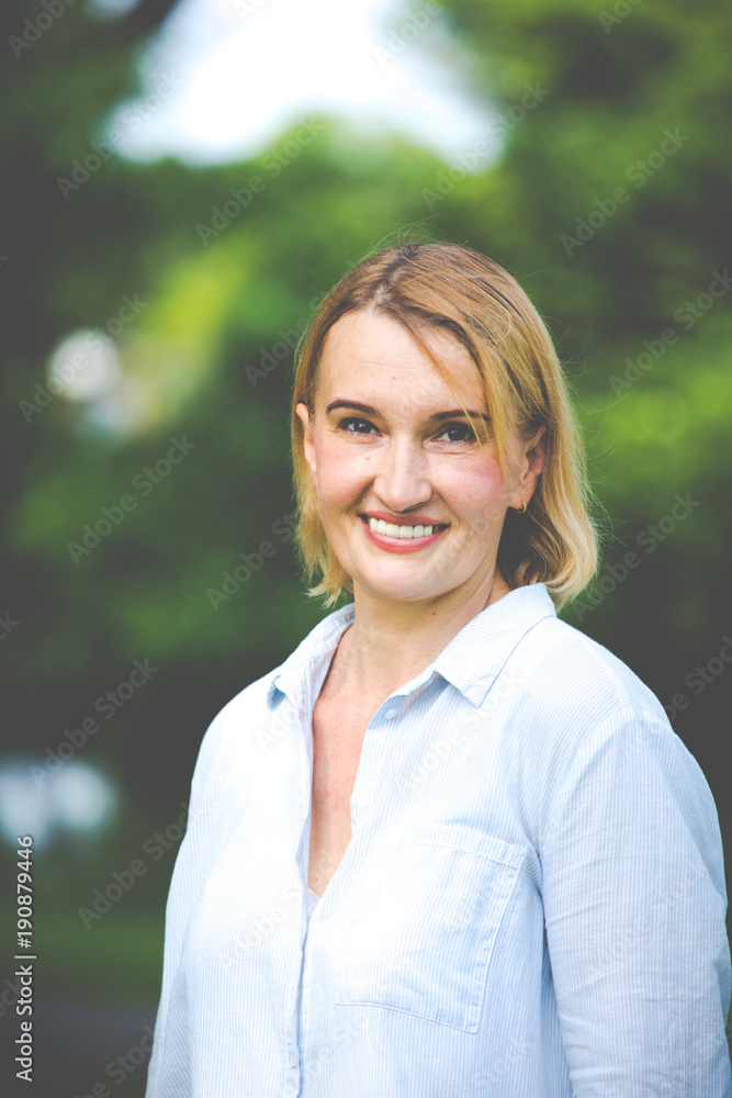 Portrait of older woman smiling natural light in park Portrait of older woman smiling natural light in park