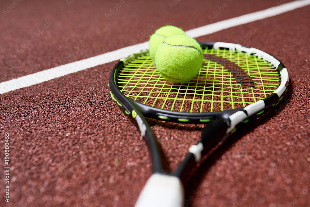 Close up view background of tennis racket with ball lying on court floor, copy space