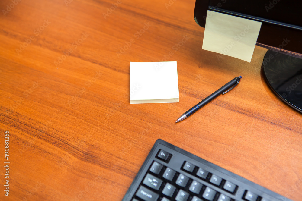 Office Desk with empty Stickers, Pen, keyboard and free space on left side Office Desk with empty Stickers, Pen, keyboard and free space on left side