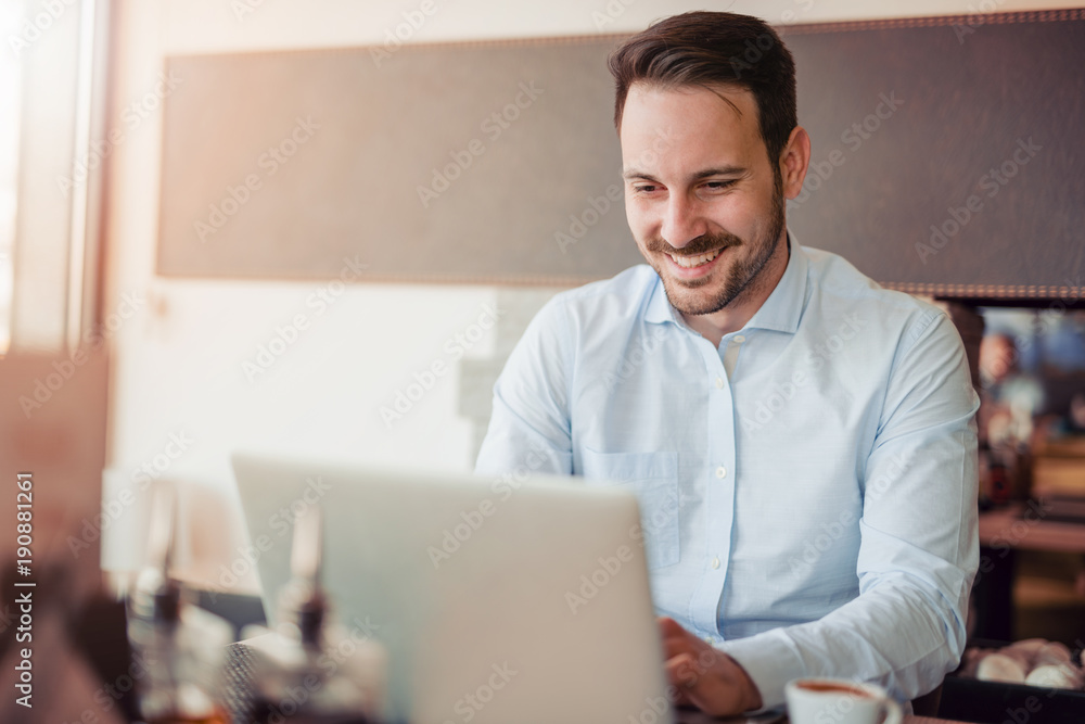 Portrait of young man sitting at his desk in the office. Portrait of young man sitting at his desk in the office.