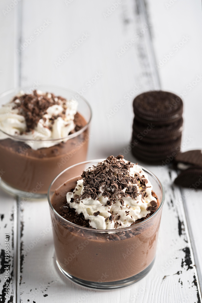 Chocolate mousse in a glasses on a white wood background. Chocolate mousse in a glasses on a white wood background.