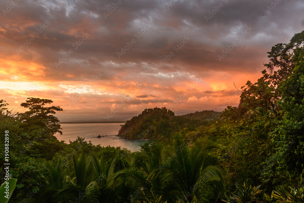 Tropical sunset with crashing waves on the coast in Costa Rica