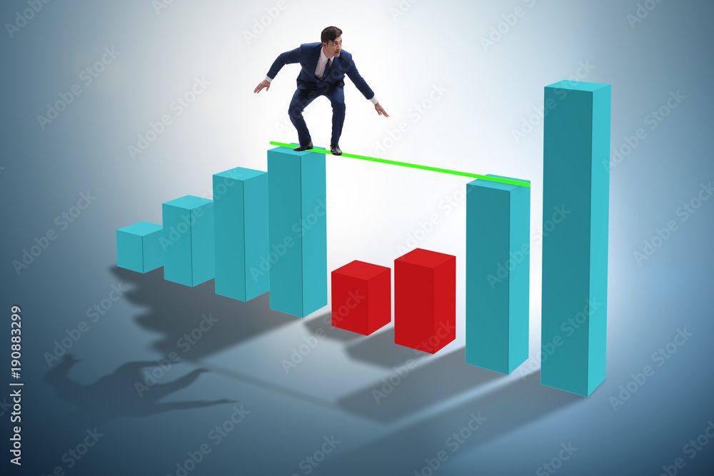 Young businessman in business concept with bar charts Young businessman in business concept with bar charts