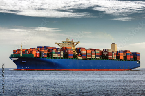 A large container ship heading out to sea