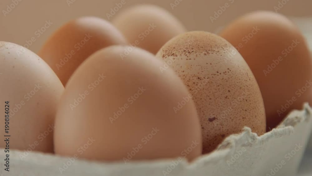 closeup of six brown eggs and woman's hand take off one of it closeup of six brown eggs and woman's hand take off one of it