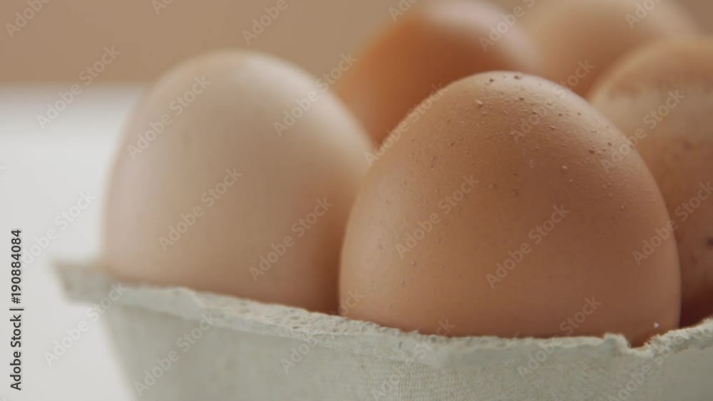 pan movemet closeup eggs and woman's hand take off the nearest egg. different brown color eggs pan movemet closeup eggs and woman's hand take off the nearest egg. different brown color eggs