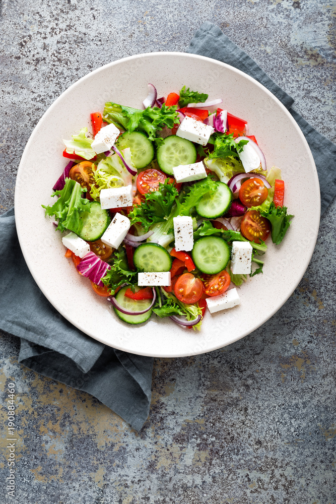 Fresh vegetable salad with feta cheese, fresh lettuce, cherry tomatoes, red onion and pepper Fresh vegetable salad with feta cheese, fresh lettuce, cherry tomatoes, red onion and pepper