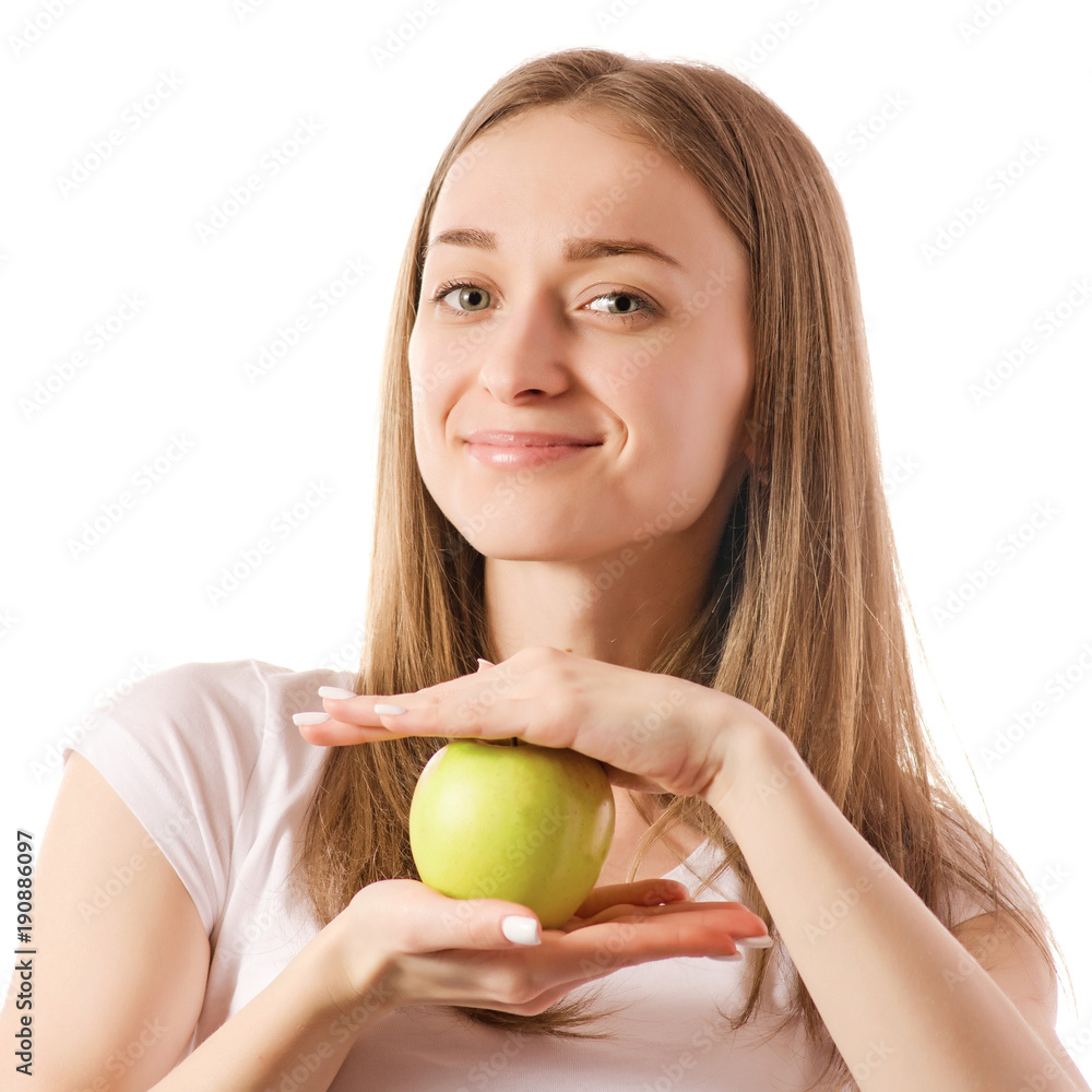 Beautiful young smiling woman holding an apple in her hands Beautiful young smiling woman holding an apple in her hands