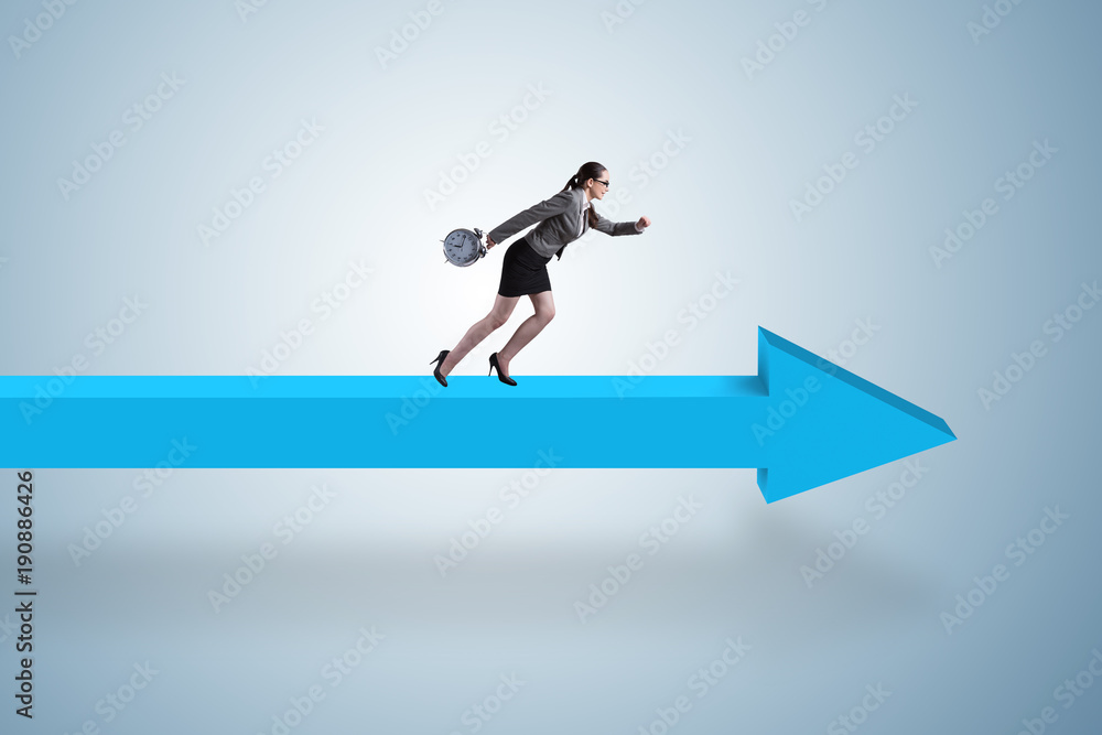 Businesswoman walking on arrow sign Businesswoman walking on arrow sign
