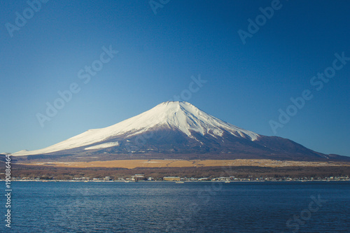 Beautiful landscape view of Fuji mountain or Mt.Fuji covered with white snow in winter seasonal at Yamanaka Lake, Japan.