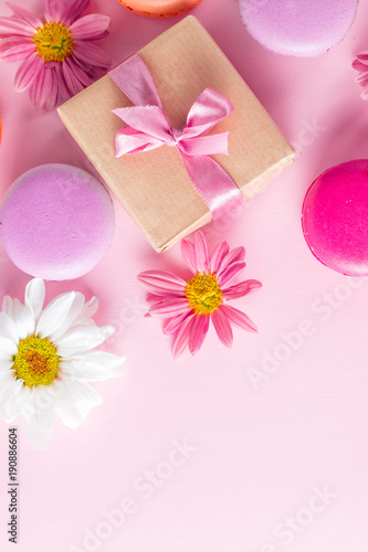 Photo of cake macarons, gift box, tea, coffee, cappuccino and flowers. Sweet romantic food macaroon concept. Morning breakfast and presents.