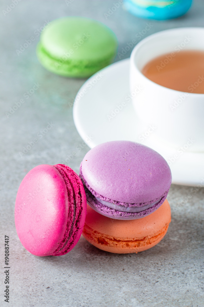 Photo of cake macarons, gift box, tea, coffee, cappuccino and flowers. Sweet romantic food macaroon concept. Morning breakfast and presents. Photo of cake macarons, gift box, tea, coffee, cappuccino and flowers. Sweet romantic food macaroon concept. Morning breakfast and presents.