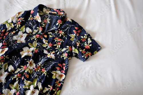 Hawaiian shirt is placed on a white mattress