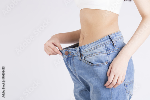 Gorgeous woman showing off her weight loss and wearing jeans large size
