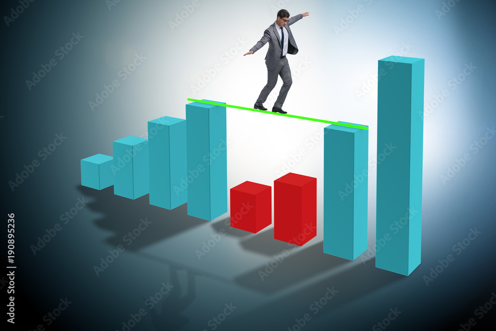 Young businessman in business concept with bar charts Young businessman in business concept with bar charts