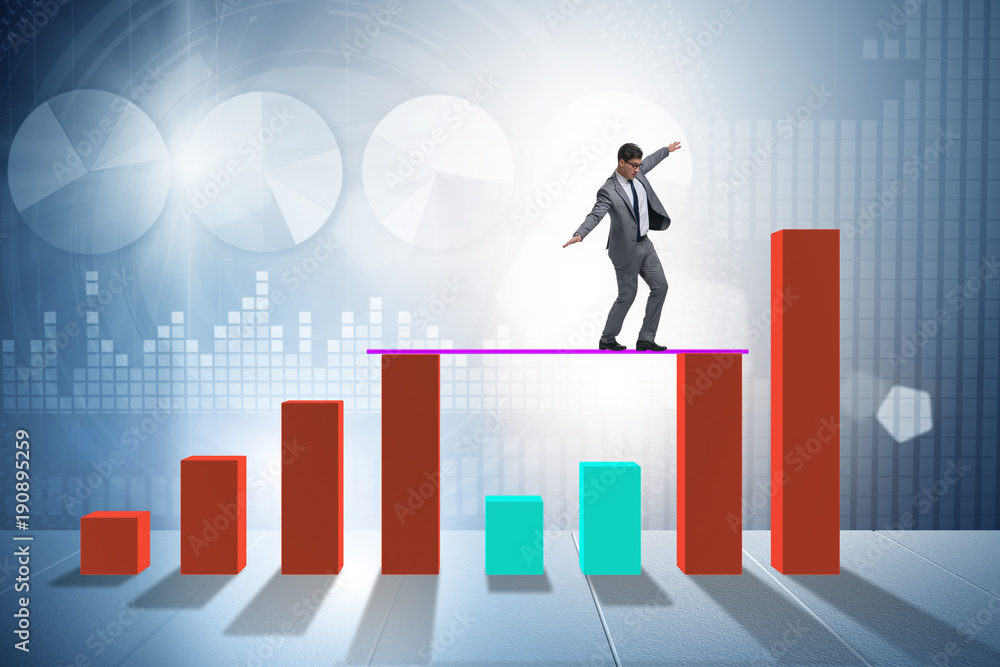 Young businessman in business concept with bar charts Young businessman in business concept with bar charts