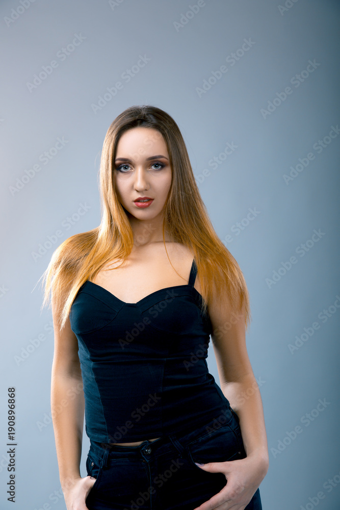 Beautiful caucasian woman dressed in black dress posing at studio. Beautiful caucasian woman dressed in black dress posing at studio.