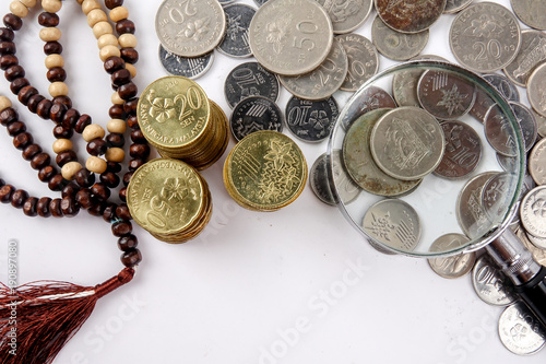 Rosary and coins. Islamic Banking/Finance concept. photo