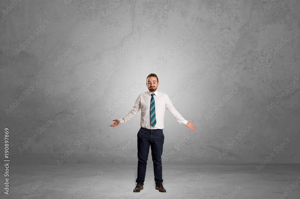 Alone businessman standing in a dark room Alone businessman standing in a dark room