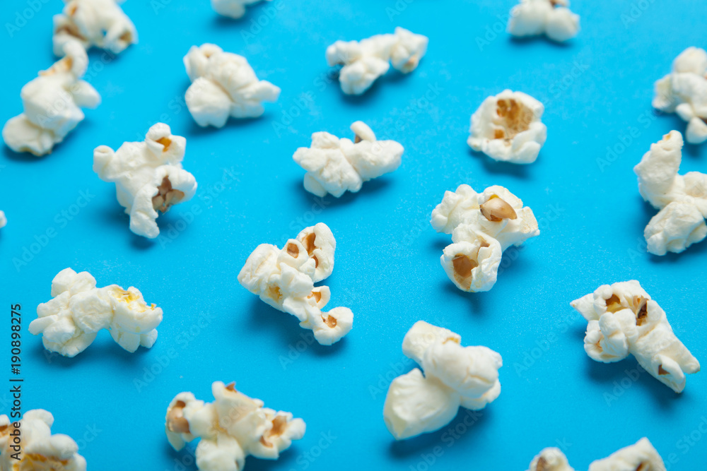 White popcorn on blue background. Flat lay pattern. White popcorn on blue background. Flat lay pattern.