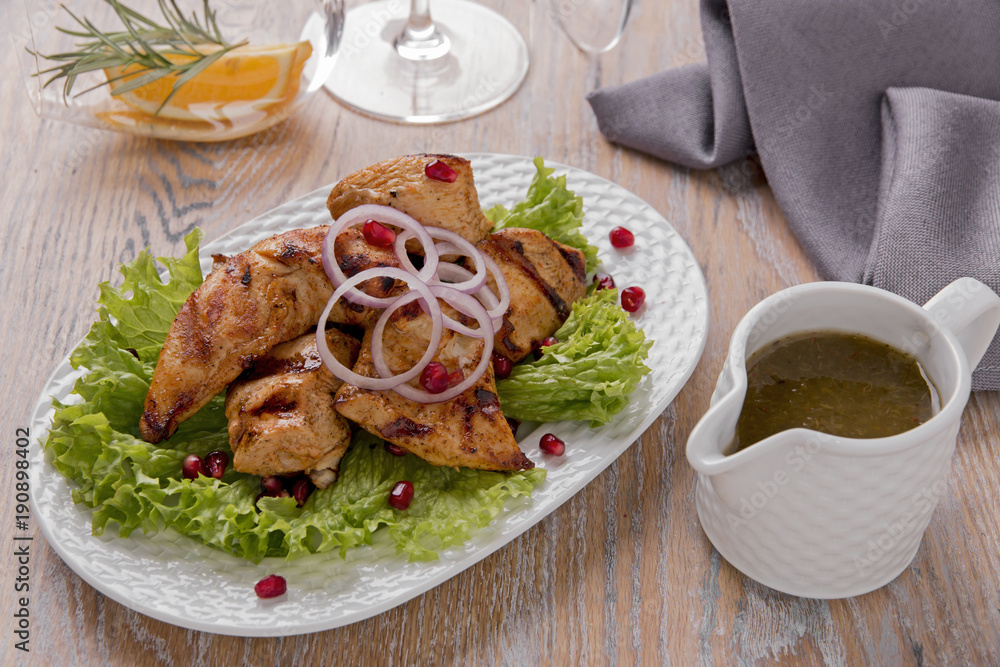 pieces of chicken fillet grilled with sauce on a plate pieces of chicken fillet grilled with sauce on a plate