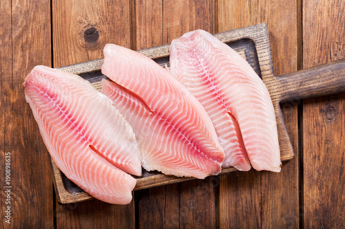 Sticker fresh fish fillet on wooden board