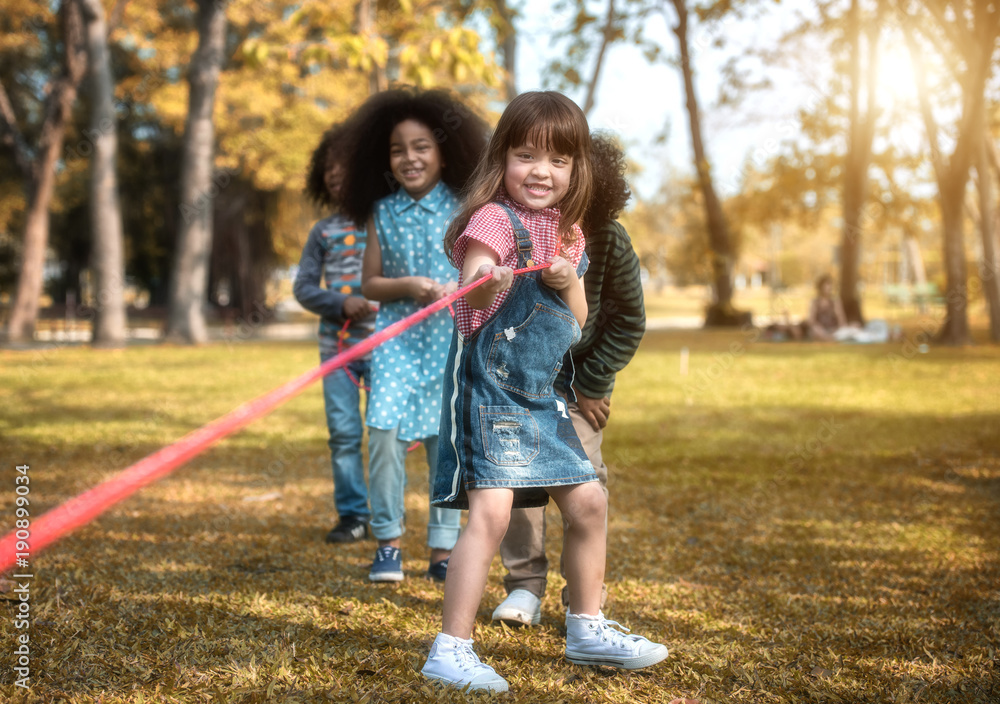 Children are happy to play tug at the park. Soft focus concept. Children are happy to play tug at the park. Soft focus concept.