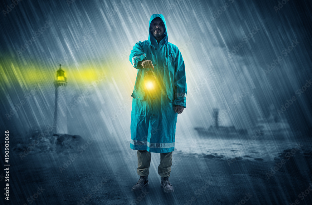 Fototapeta premium Man coming with lantern at coast concept