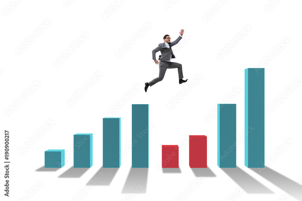 Young businessman in business concept with bar charts Young businessman in business concept with bar charts